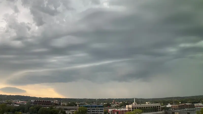 Dark storm clouds rolling in over a town skyline